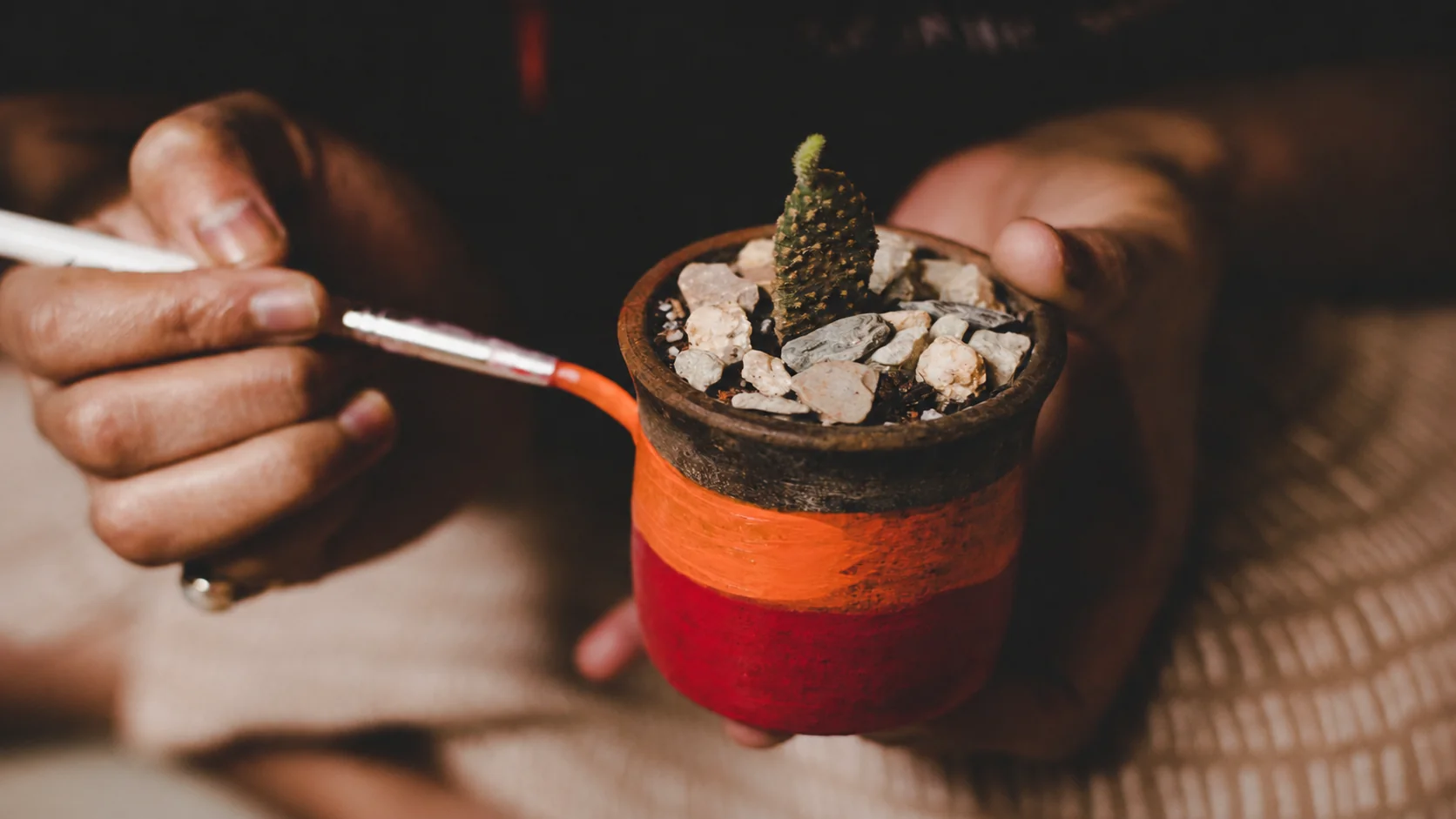 Artisan painting a handmade clay pot